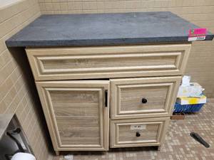 lot 24044 image: Wood Style Metal Bathroom Cabinet W Soapstone Top