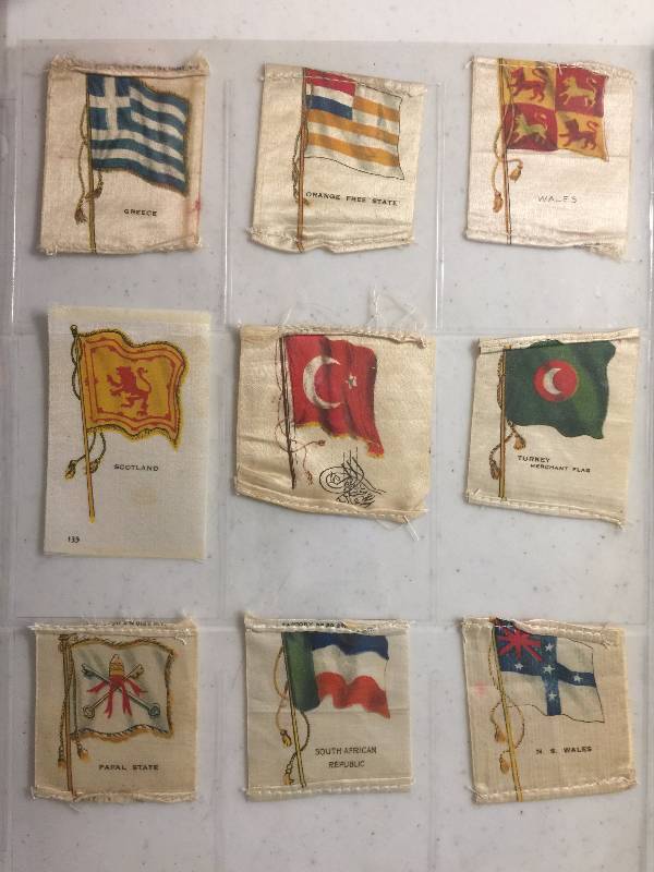 lot 1059 image: NINE Original 1900-1910s Tobacco Country Flag Silks including Papel State, Greece, Wales, South Africa, and more