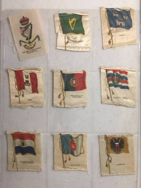 lot 1060 image: NINE Original 1900-1910s Tobacco Country Flag Silks including Peru, Dutch, Portugal, Ireland, Dubland, and more