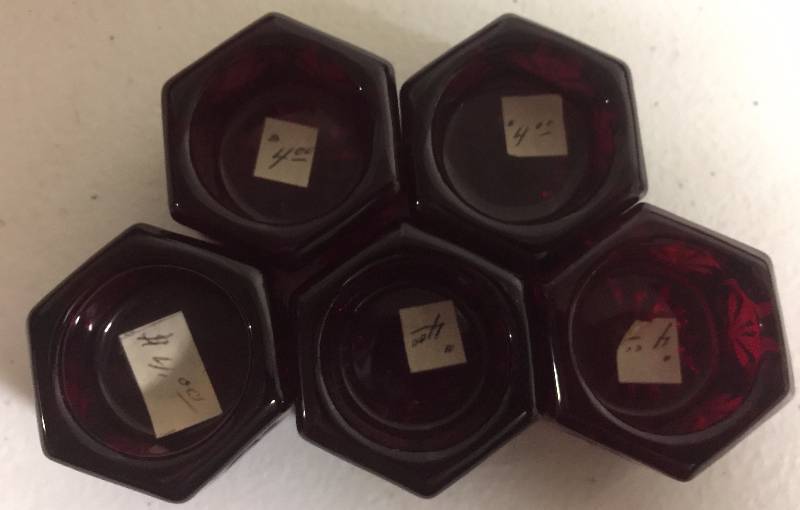 lot 1231 image: Five Small Pentagon Shaped Deep Ruby Red Candle Holders 1 Inch Each