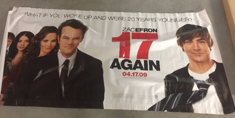 lot 1276 image: 17 Again Original Vinyl Display Banner wZac Efron and Matthew Perry 4 ft x 8 ft with Original Box and Dowels