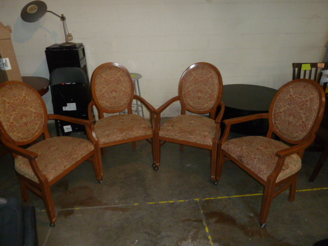 lot 4 image: SET OF FOUR PADDED WOODEN CHAIRS WITH WHEELS ON FRONT TWO LEGS