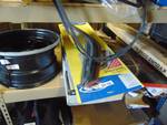 Contents of Shelf: automotive parts, steel wheel, window vent visers, window motor and more.