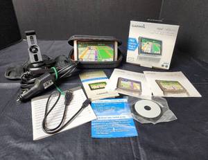 lot 123 image: Garmin Nuvi with Automobile Cords, Garmin Dash Holder, and Garmin Case