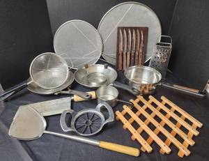 lot 239 image: Splatter Screens, Skillets, Grater, Wood Trivet, and Assorted Utensils