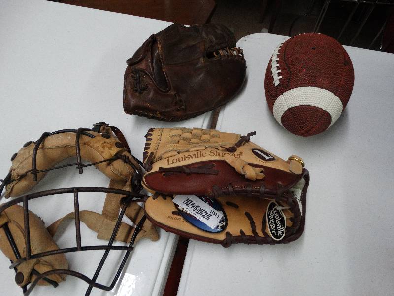 lot 1041 image: Baseball mitt, catchers mitt, vintage catchers mask and football piggy bank.