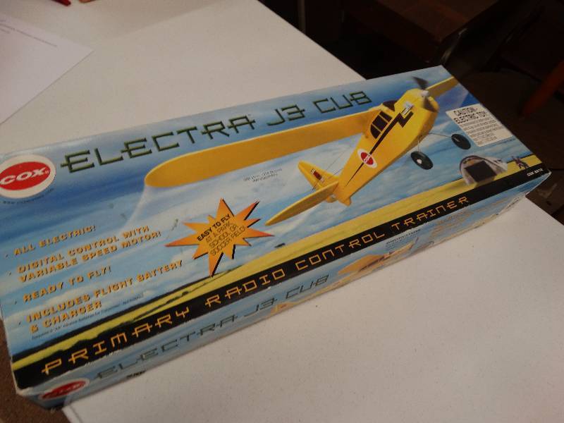 lot 1050 image: Cox electric J3 cub remote control plane.