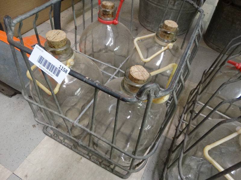 lot 1158 image: 4 glass gallon containers w metal carrier.