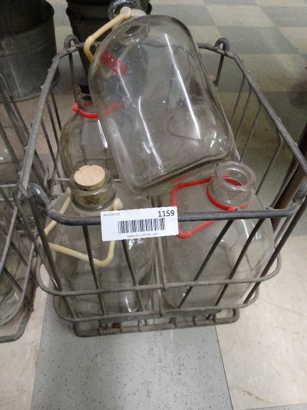 lot 1159 image: 4 glass gallon containers w metal carrier.