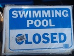 Two new swimming pool closed signs