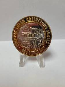lot 32 image: CRIPPLE CREEK GAMING TOKEN-JOHNNY NOLANS SALOON