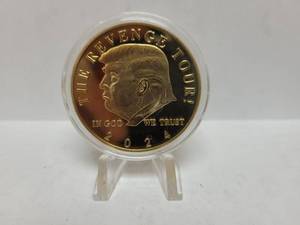 lot 556 image: 2024 GOLD TONE THE REVENGE TOUR DONALD TRUMP COIN