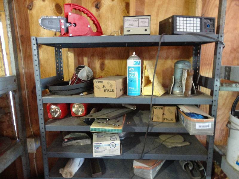 lot 354 image: Metal shelf w contents on shelf- saw, flash lights, nails, base station