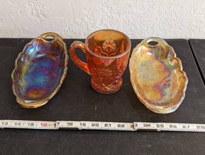 lot 600 image: (2) Vintage Iridescent Orange Saucers and Marigold Orange Mug.