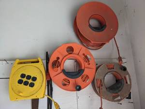 lot 1064 image: (3) Extension Cord Holders with Cords and Portable Power Reel.