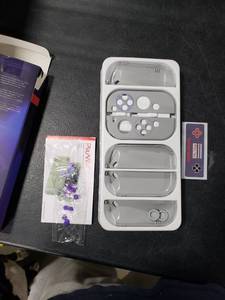 lot 2699 image: PlayVital AlterGrips Protective Slim Case for Nintendo Switch OLED, Ergonomic Grip Cover for Joycon, Dockable Hard Shell for Switch OLED wThumb Grip Caps & Button Caps - Classics SNES Style