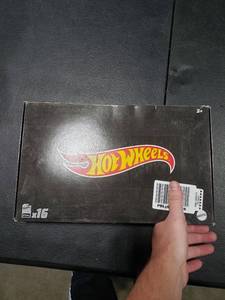 lot 2850 image: Hot Wheels Basics Black Box, 16 First-Appearance Toy Cars in 164 Scale, Possibly Includes a Treasure Hunt Car, Toy for Collectors & Kids 3 Years Old & Older
