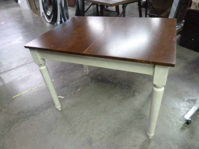 lot 233 image: DINING TABLE WITH FLIP OUT LEAF - HAS 3 DENTS AND A BAD CORNER