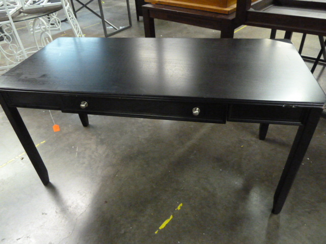 lot 211 image: BLACK TABLE WITH DRAWER - HAS BAD CORNERS