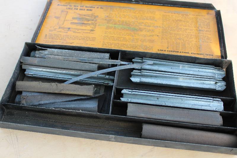 lot 2183 image: Lisle Pin Hole Hone in Case (partial - see photo for contents)