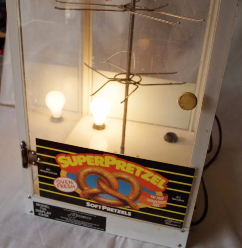 lot 6002 image: Pretzel Display Case  Warmer M# 750 - Powers on. One light socket needs repair (see photo) - w hanging sign COOL