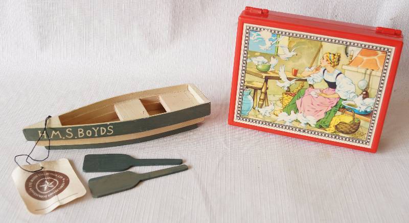 lot 6025 image: Lot of collectibles - Boyds Collection Boat w Oars and Vintage German Puzzle Blocks in a case w pictures (see hinge is broken on case)
