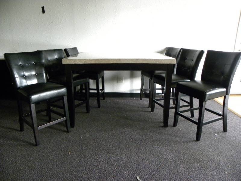 lot 7118 image: 36 T, 5454 WD. Looks like Square Cut Pegasus Granite Top Table w 6 Chairs.