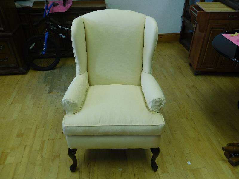 lot 9183 image: Soft Fabric Wingback Cream Colored Chair.