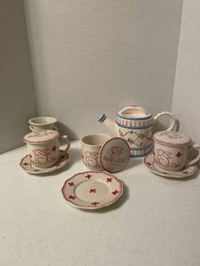 lot 1113 image: Tea pot, tea infusers and teacups with lids and saucers