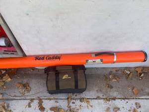 lot 3604 image: Plano tackle box with fishing pole inside orange colored rod caddy
