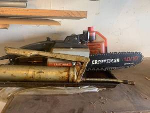 lot 3610 image: Craftsman chainsaw. With grease gun and small container of 2cycle engine oil