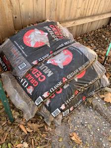lot 5200 image: Several bags of old cedar mulch- may be moldy