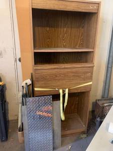 lot 3502 image: Garage shelves(repurposed entertainment center) 71 x 30 x 15. Comes with miscellaneous metal, pipes and some wood (approximately 78 x 24)