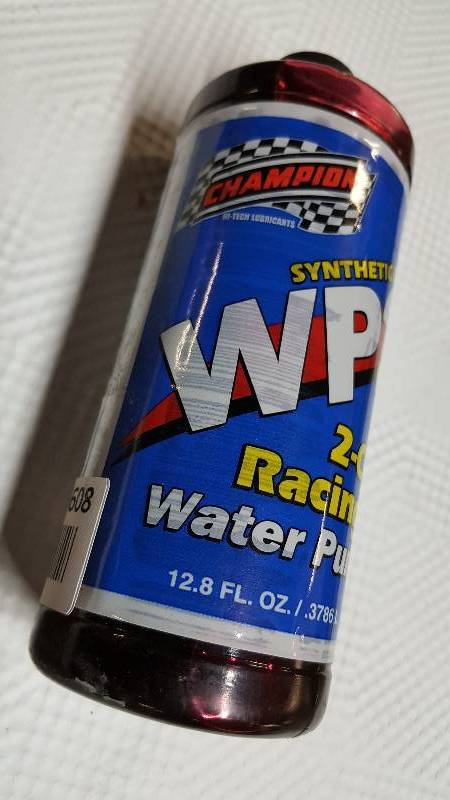 lot 6608 image: New bottle of Champion 2 cycle racing engines special water pump lubricant