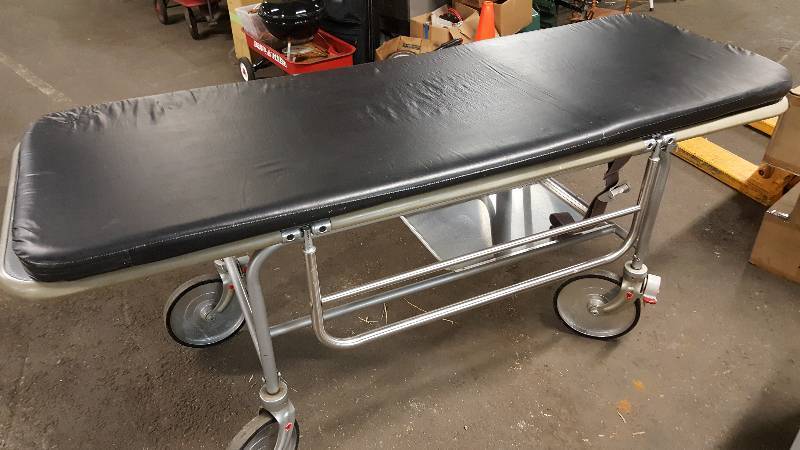 lot 6540 image: In amazing condition is this stainless chassis Gurney from a medical center doctors office.