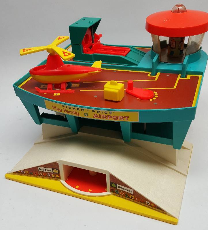 lot 6561 image: Good looking old Fisher Price air port and helicopter landing pad.  Crank the handle and the blades turn.