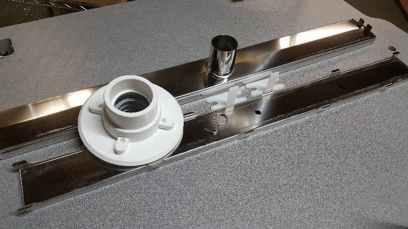 lot 6472 image: New in the box is this QuARTz Linear Drain made to be built in the shower floor as the tile is being finished.