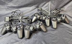lot 157 image: (4) Vintage Sony PlayStation Controllers