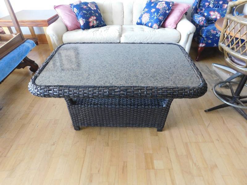 lot 8039 image: 22 T, 49 W, 29 D. - Wicker and Granite Slate Top 2 Tier Outdoor Table.