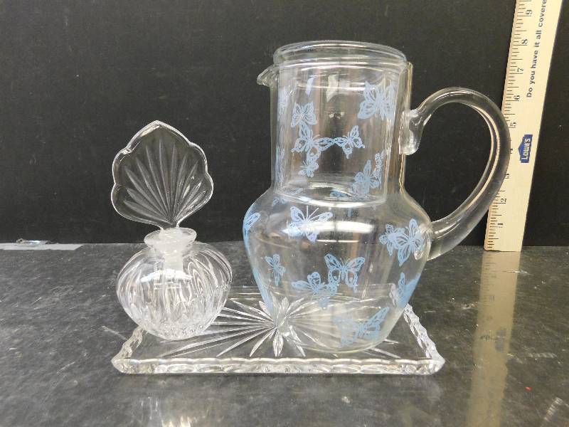 lot 8252 image: Crystal Glass Tray. Glass Perfume Bottle with Stopper. Butterfly Decorated Juice Pitcher w matching Cup.