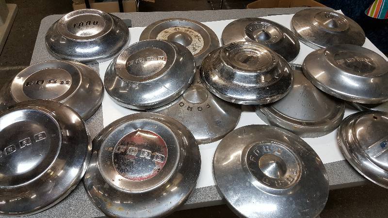 lot 6390 image: Big batch of all different years early Ford hub caps