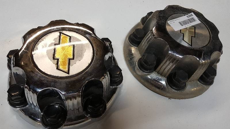 lot 6396 image: Pair of mismatched Chevy 8 lug chrome center caps