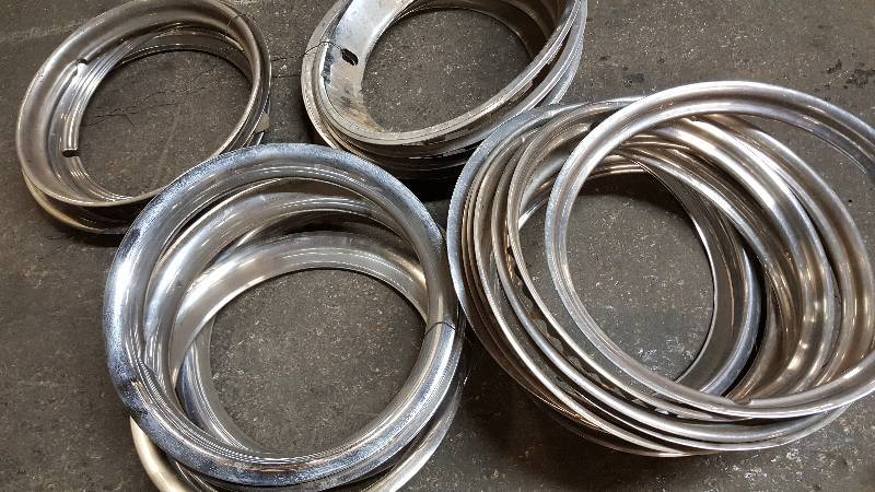 lot 6415 image: A huge amount of early and late stainless wheel trim rings even a few sets.  Get in the trim ring business with this lot