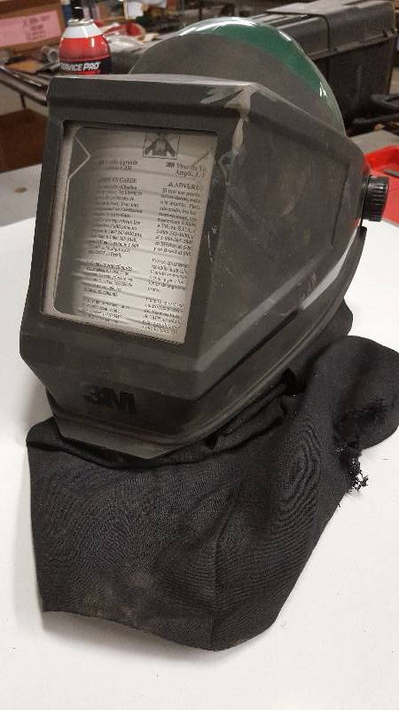 lot 6374 image: I dont believe this sand blasting helmet has been used much.  Not sure how the helmet skirt got the hole in it.