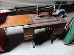 Antique Damascus grand treadill sewing machine w/cabinet.