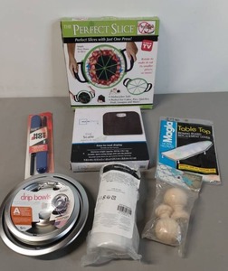lot 32 image: NIP Household Variety - Scale, PizzaPie Slicer, Mattress StorageMoving Bag, Ironing Board Cover, Finials, Stove Drip Pans, Candle Lighter