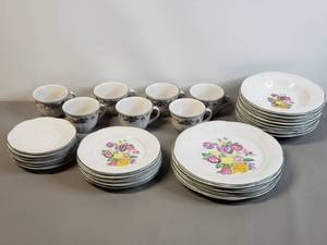 lot 79 image: Pansy Basket Print Dishes 7 cups, 6 saucers ( one with chip )8 Pasta Bowls, 5-10.5 Dinner Plates, 5 Salad Plates,
