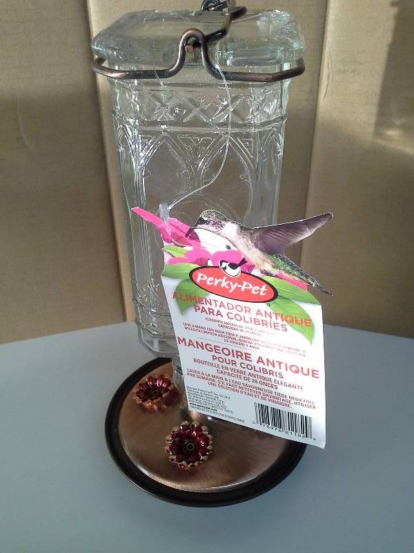 lot 6105 image: Perky-Pet Glass Antique Bottle Hummingbird Feeder, Clear