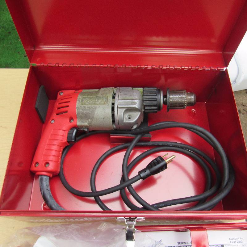 lot 4635 image: Milwaukee Electric Drill 38 drive - Pistol Hammer Drill -  w case & handles - slightly used in good working condition