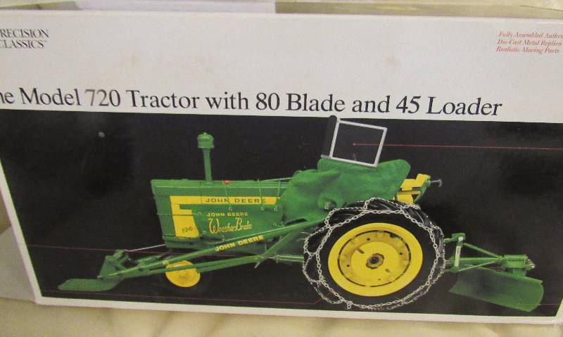 lot 7003 image: John Deere Replica Toy - Model 720 Tractor w. 80 blade and 45 loader - In original box Pristine Condition, metal collectors medallion included